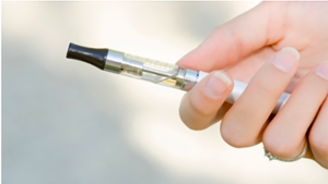 a hand holding a vape, an e-cigarette.